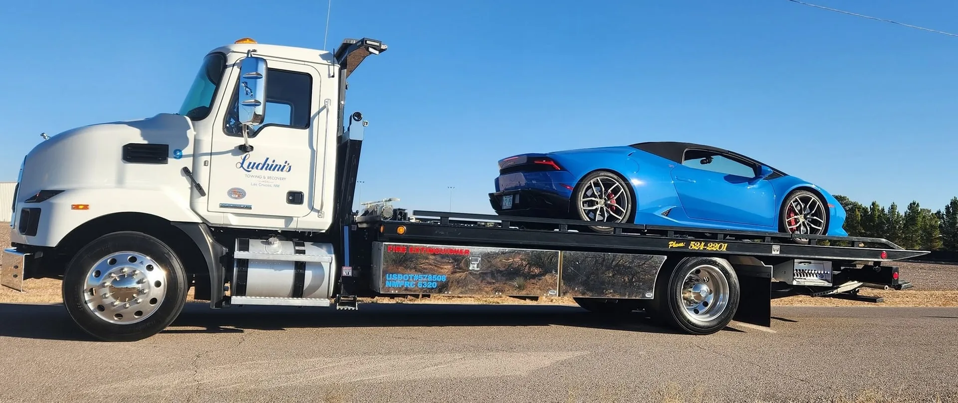 Luchini's flatbed transporting a sports car